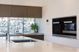 smoky bronze liquid metal; metal veneer; decorative metal coating; award-winning kitchen; designer kitchen; rangehood; cupboards
