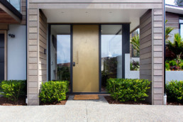 brass liquid metal, brass moonrock finish; statement front door; brass door; metal veneer