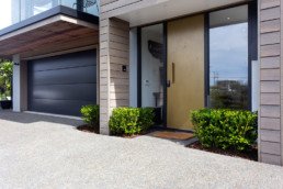 Brass moonrock; statement front door; entrance way; brass liquid metal; brass metal veneer