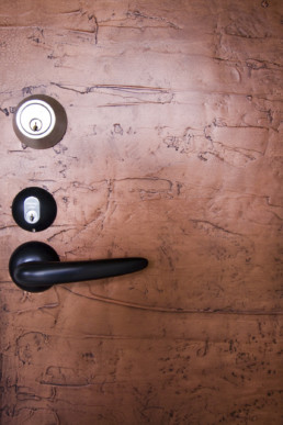 Textured & black waxed copper door by Metalier liquid metal