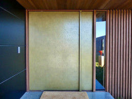Brass moonrock; statement front door; entrance way; brass liquid metal; brass metal veneer