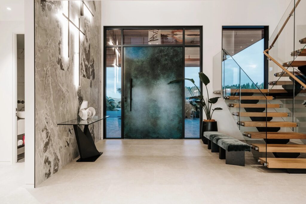 Metalier liquid metal patinated green entry door in a luxury modern residential foyer – New Zealand.