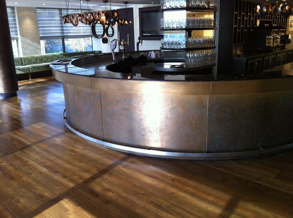 Metalier liquid metal bronze bar front with a custom aged patina in a contemporary hospitality setting – Dubai.