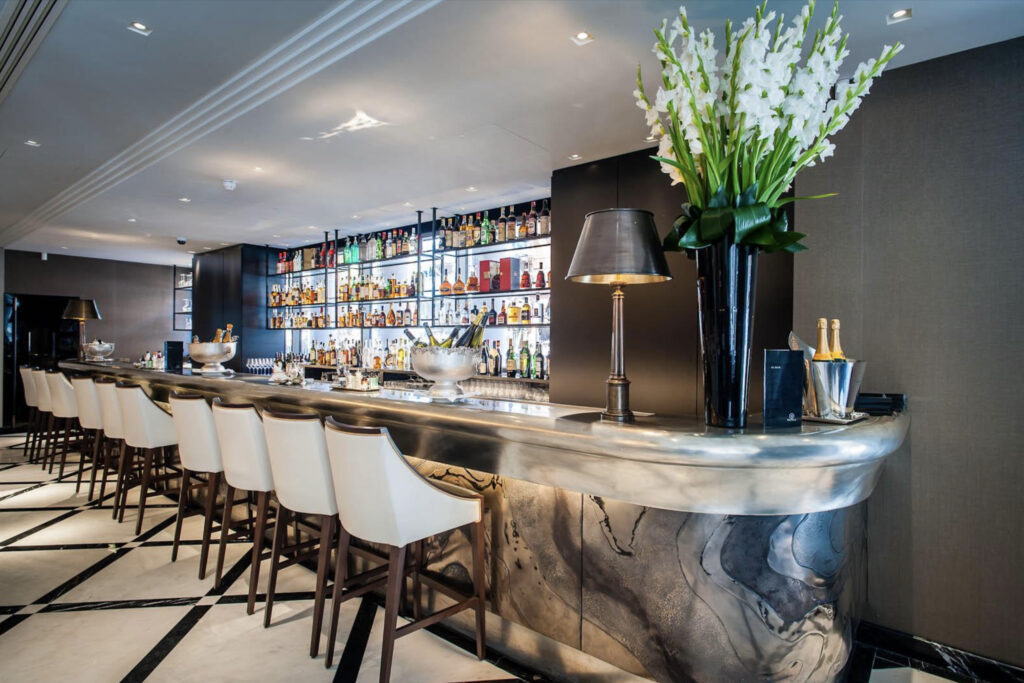 Metalier liquid metal gunmetal bronze bar front with an organic texture in a luxury hotel lounge – India.