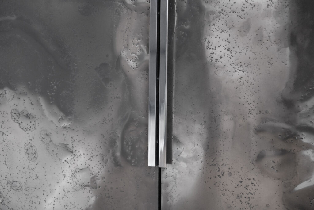 Detailed close-up of Metalier liquid metal polished and textured gunmetal bronze finish on bespoke furniture doors – Netherland.