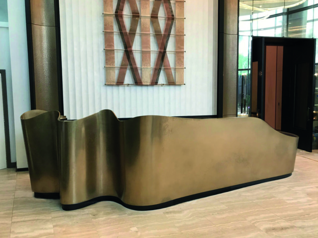 A contemporary curved bar featuring a Metalier liquid metal bronze finish with a custom aged blue-green patina – Philippines.