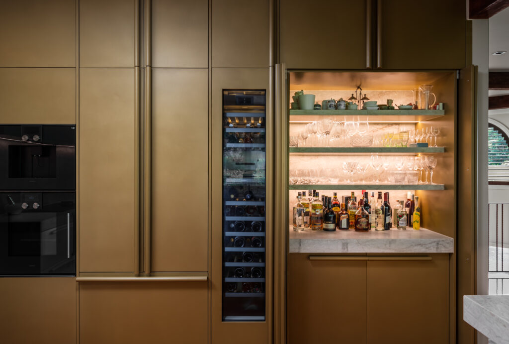 Metalier liquid metal olive gold seamless cabinetry and integrated wine fridge in a luxury custom kitchen – Florida.