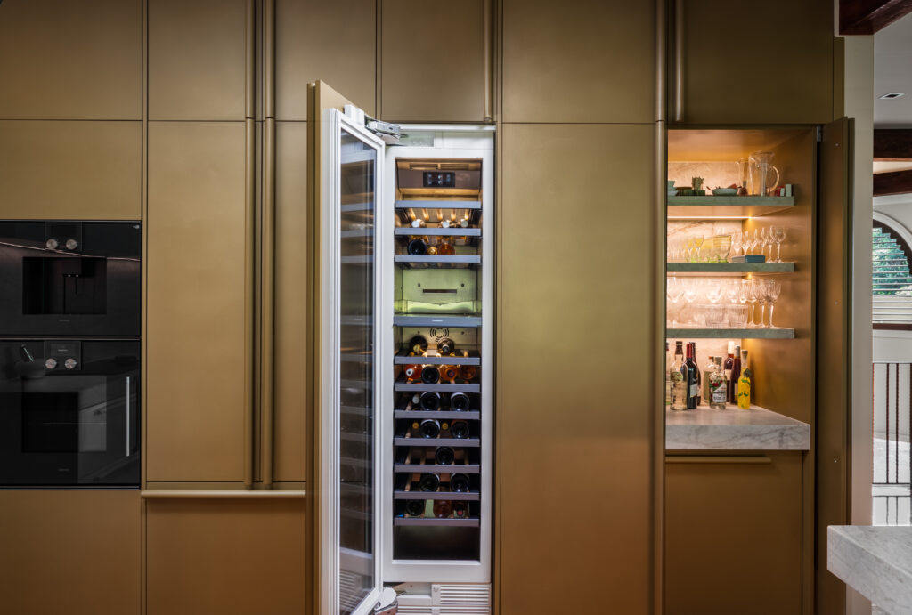 Metalier liquid metal olive gold seamless cabinetry and integrated wine fridge in a luxury custom kitchen – Florida.