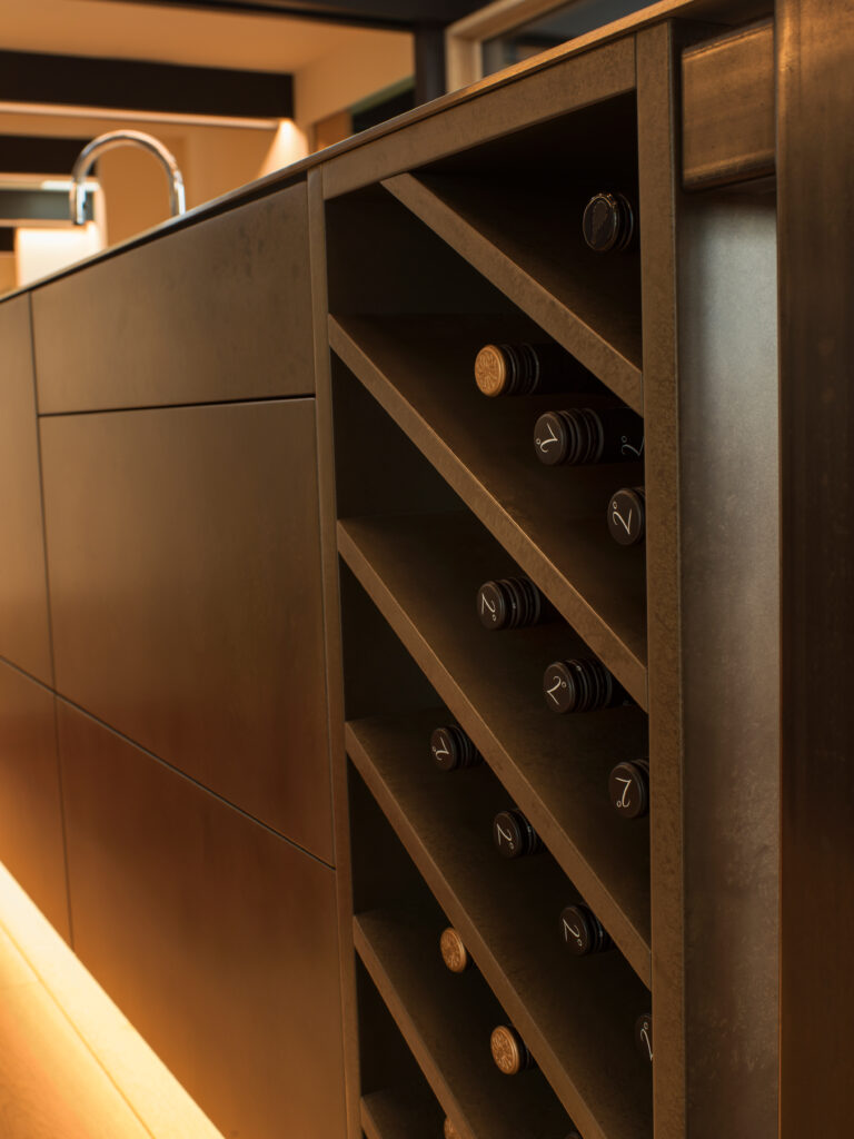 Metalier liquid metal gunmetal bronze bar front with an organic texture in a luxury hotel lounge – India.