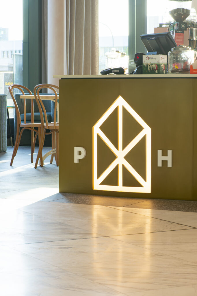 Bespoke tiered office reception desk with a Metalier liquid metal polished gunmetal finish – London, England.