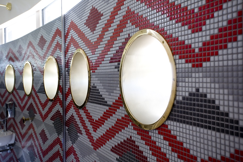 Porthole windows combining brass and Metalier decorative liquid metal at Auckland's Sugar Club