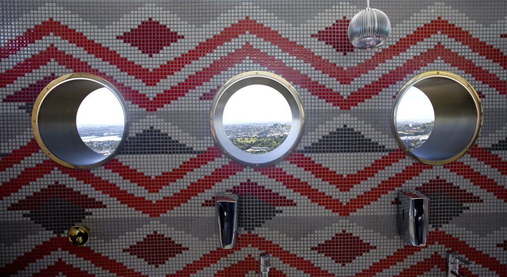 Brass-rimmed porthole windows with Metalier Liquid Metal Finishes at Auckland's Sugar Club