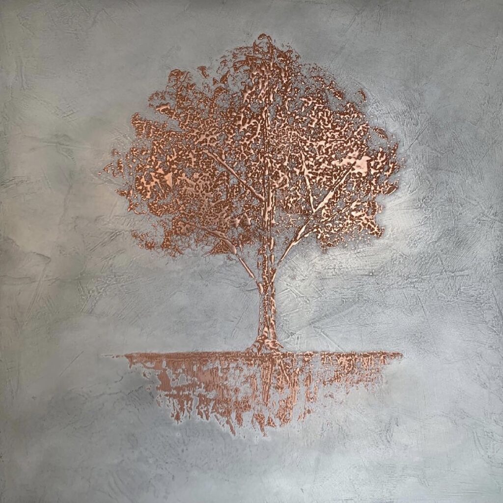 Copper tree motif created with a Metalier decorative metal finish on a textured grey surface.