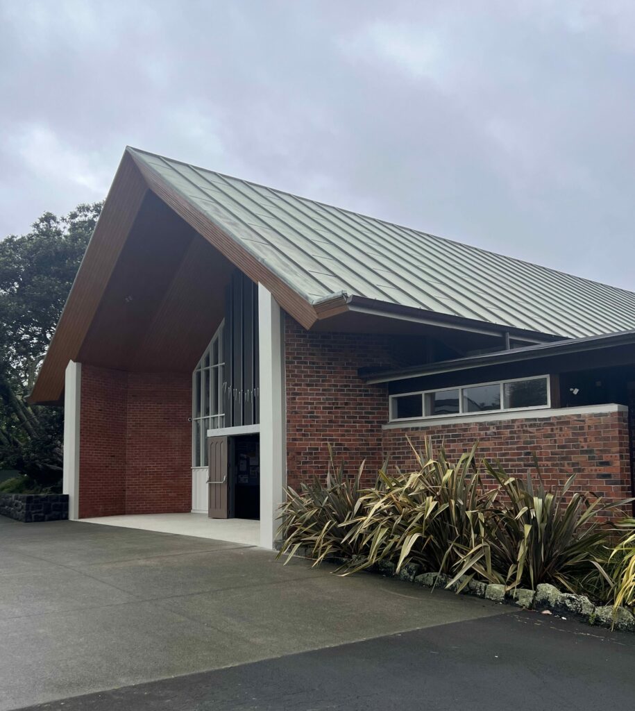 A copper roof on a church turns green. The doors are aged Metalier bronze.