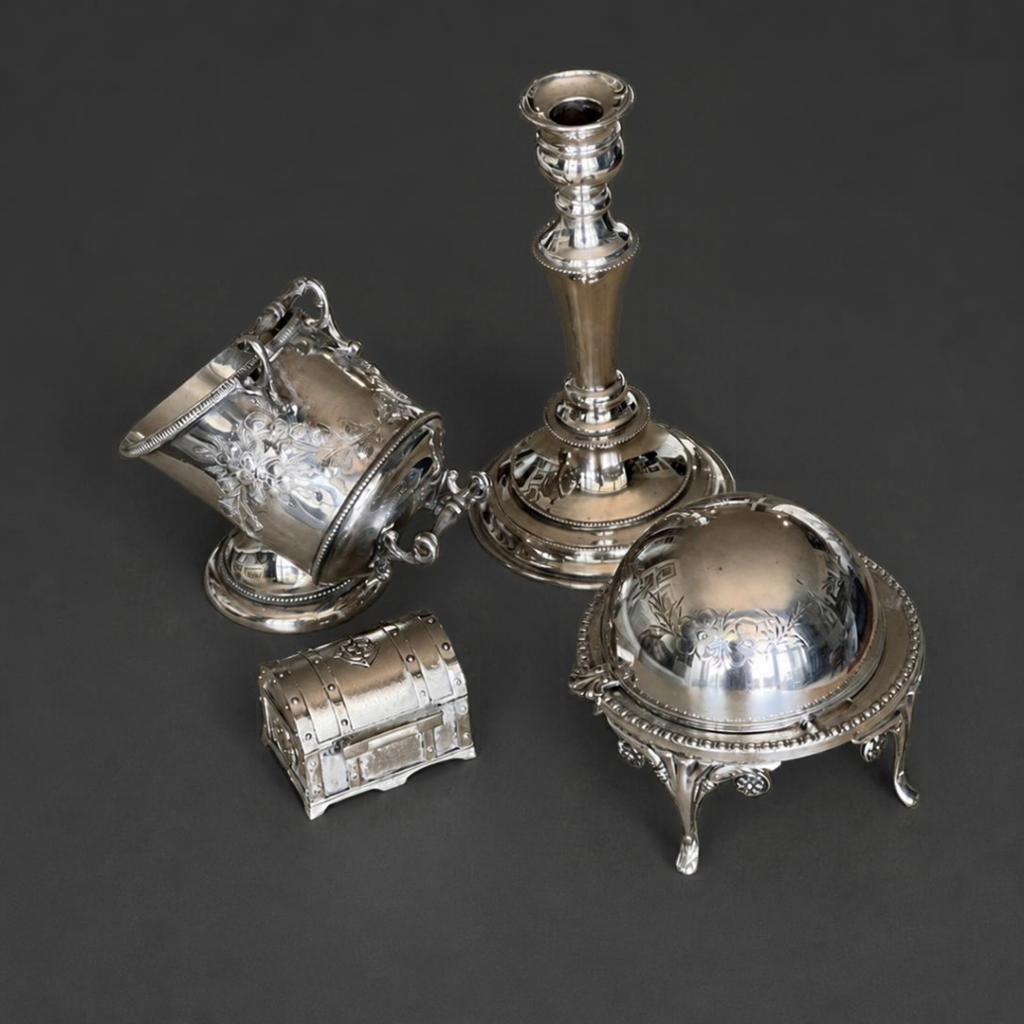 Polished silver pieces arranged on a charcoal background, illustrating polished metal and surface protection.